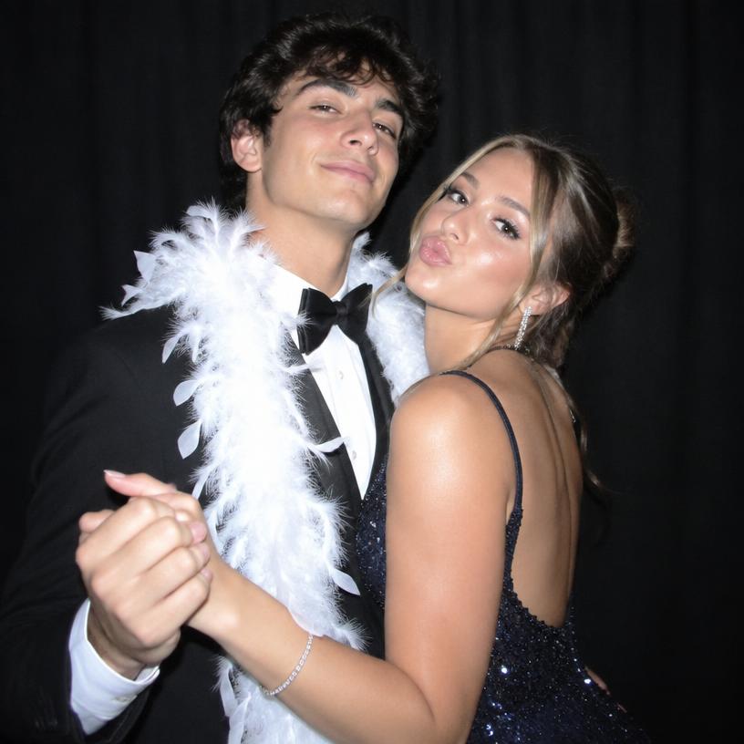 Prom couple posing in the photobooth